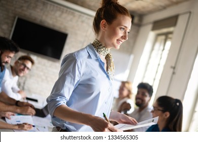 Group of young businesspeople or designers work with new startup project in office - Shutterstock ID 1334565305