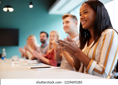 Group Of Young Candidates Sitting At Boardroom Table Applauding Presentation At Business Graduate Recruitment Assessment Day - Shutterstock ID 1229695285