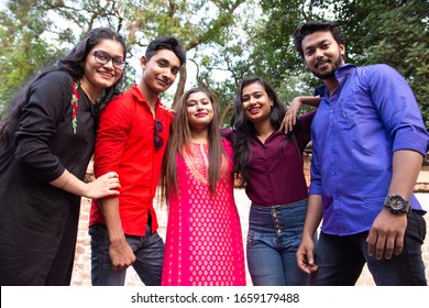 Group Of Young Cheerful Indian People Bonding To Each Other And Smiling