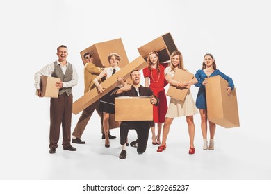 Group Of Young Cheerful, Stylish People Holding Big Cardboard Boxes Isolated Over White Studio Background. Black Friday, Sales, Shopping. Concept Of Retro Fashion, Style, Youth Culture, Emotions, Ad