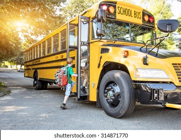 A group of young children getting on the schoolbus