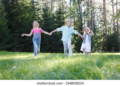 Group Of Young Children Running Towards Camera In Park