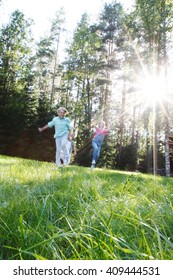 Group Of Young Children Running Towards Camera In Park