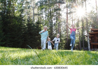 Group Of Young Children Running Towards Camera In Park