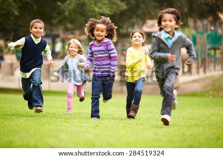 Group Of Young Children Running Towards Camera In Park