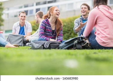 Group of young college students sitting in the park - Powered by Shutterstock