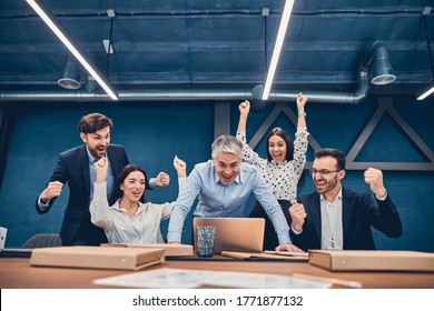 Group Of Young Coworker Working Together In Modern Coworking Studio And Feeling Pride Of Cool Idea