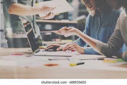 Group of young coworkers working together in modern office.Woman talking with colleague about new startup project.Business people brainstorming concept.Horizontal,color filter - Powered by Shutterstock