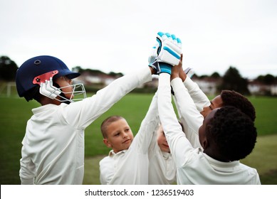 Group of young cricketers doing a high five - Powered by Shutterstock