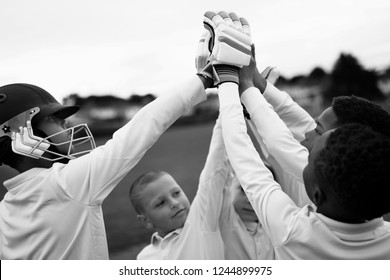 Group of young cricketers doing a high five - Powered by Shutterstock