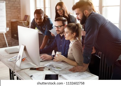 Group of young designers working as team - Shutterstock ID 1132602758