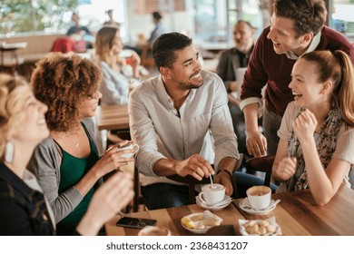 Group of young and diverse friends having coffee together in a cafe or bar - Powered by Shutterstock