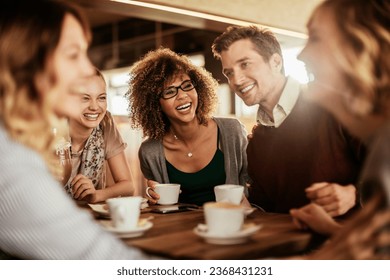 Group of young and diverse friends having coffee together in a cafe or bar - Powered by Shutterstock