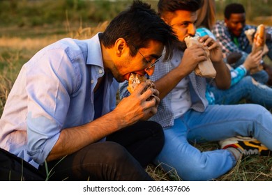 The Group Of Young Diverse People Eating Fastfood On Nature