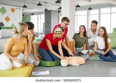 group of young diverse people practice first aid training by hand, first aid course in CPR dummy. concept of training skills to save lives, medicine - Powered by Shutterstock