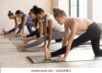 Group of young diverse sporty people doing yoga Half splits exercise, Ardha Hanumanasana pose, mixed race female students training atdoor at club sport or studio. Well being, wellness concept - Shutterstock ID 1326343811