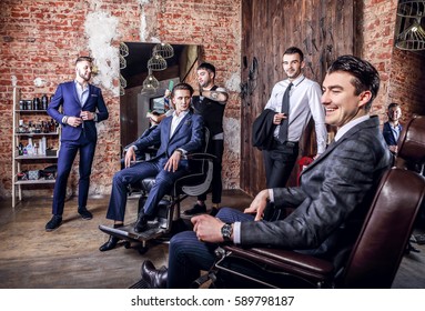 Group Of Young Elegant Positive Mens Pose In Interior Of Barbershop.