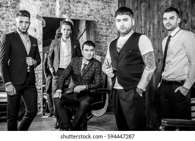 Group Of Young Elegant Positive Mens Pose In Interior Of Barbershop. Black-white Photo.