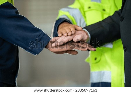 Group of young Engineer United stack hands or join hand teamwork together with Spirit diversity solidarity team Partner in metal sheet factory. Joins hands together teamwork meetings empower.