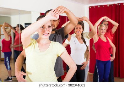 Group Of Young European People Dancing Salsa In Studio