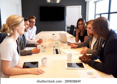 Group Of Young Executives Holding A Work Meeting In A Conference Room