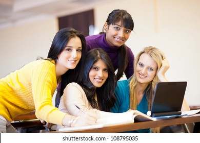 Group Of Young Female College Students Using Laptop In Classroom