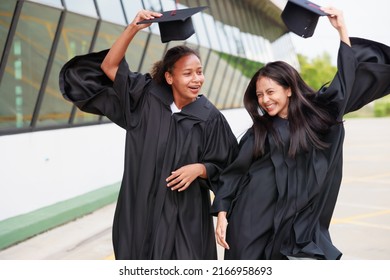 group young female student wearing gown and graduating. Happy graduate success and celebration. Congratulation