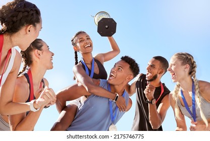 Group Of A Young Fit Diverse Team Of Athletes Celebrating Their Victory With A Golden Trophy. Team Of Active Happy Athletes Rejoicing After Winning An Award Or Trophy After A Competitive Race