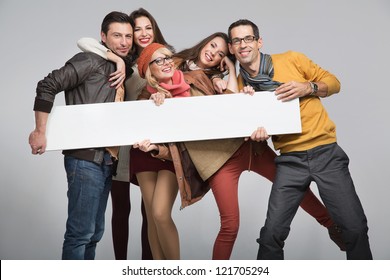 Group of young friends with advert board
