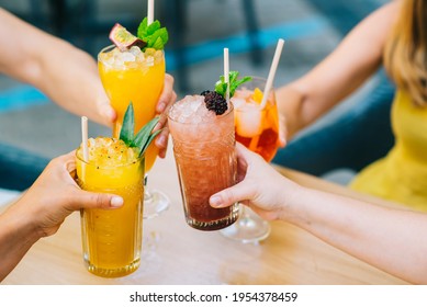 Group of young friends clinking glasses with glasses celebrating in the afternoon on the terrace - Shutterstock ID 1954378459