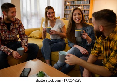 A Group Of Young Friends Drinking Coffee Together While Hanging Out On A House Party And Having Fun