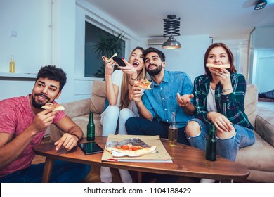 Group Of Young Friends Eating Pizza And Watching Tv.Home Party.Fast Food Concept.