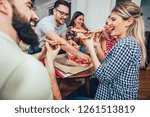 Group of young friends eating pizza.Home party.Fast food concept.