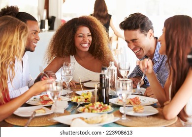 Group Of Young Friends Enjoying Meal In Outdoor Restaurant - Shutterstock ID 223908613