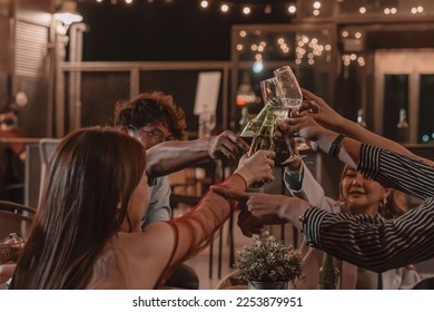 Group of young friends enjoying meal and celebrating friendship in pub and restaurant - Powered by Shutterstock