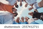 Group of young friends is forming a circle, putting their arms around each other