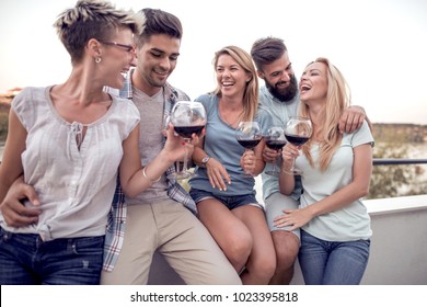 Group Of Young Friends Having Fun ,drinking Red Wine And Enjoying Hot Summer Days.