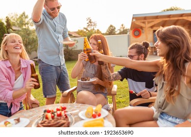 Group Of Young Friends Having Fun At Backyard Barbecue Party, Drinking Beer And Enjoying Sunny Summer Days Outdoor