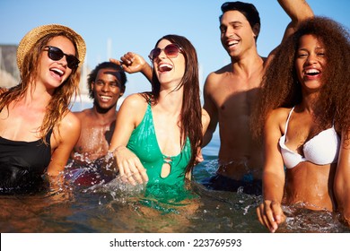 Group Of Young Friends Having Fun In Sea Together