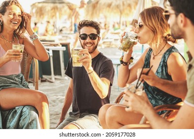 Group Of Young Friends Having A Party At The Beach Bar.