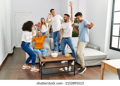Group of young friends having party smiling happy and dancing at home. - Shutterstock ID 2152895513