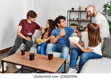 Group Of Young Friends Having Party Sitting On The Sofa At Home.