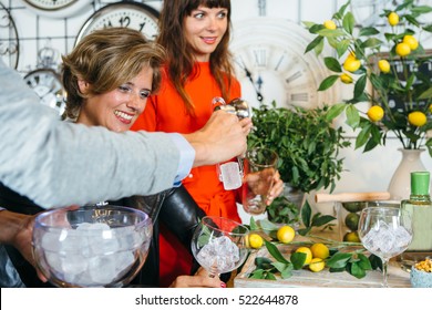 Group Of Young Friends Having Party And Making Gin Tonic Cocktails. 