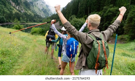 Group Of Young Friends Hiking In Countryside. Multiracial Happy People Travelling