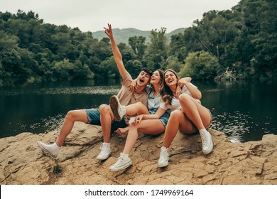 Group Of Young Friends Hiking On A Lake Vacation.