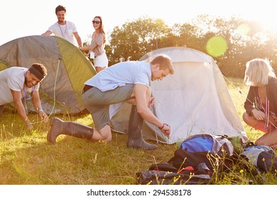 Group Of Young Friends Pitching Tents On Camping Holiday - Shutterstock ID 294538178