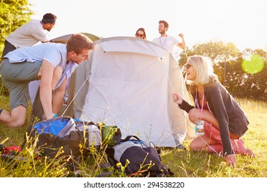 Group Of Young Friends Pitching Tents On Camping Holiday - Shutterstock ID 294538220