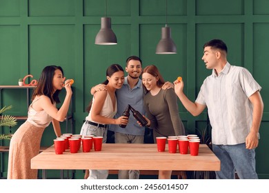 Group of young friends playing beer pong at party - Powered by Shutterstock