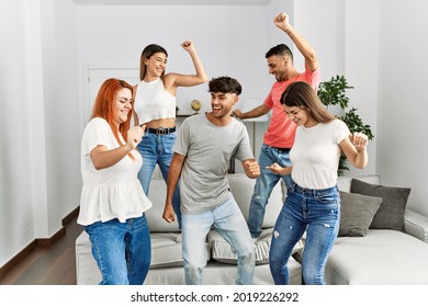 Group of young friends smiling happy and dancing at home. - Powered by Shutterstock