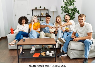 Group of young friends smiling happy watching movie at home. - Powered by Shutterstock